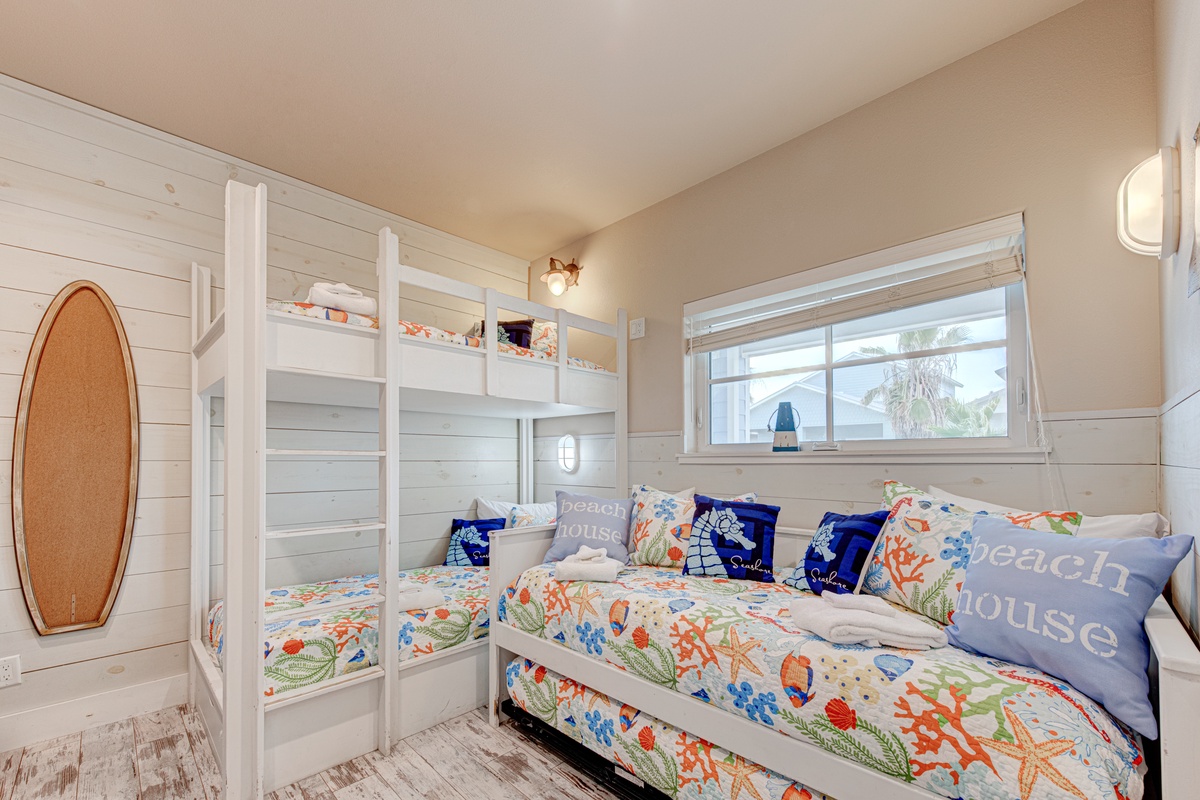 Your kids will love this cheerful bunk room with ocean-themed bedding and bright window views.