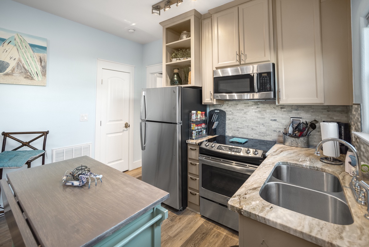 Your fully equipped kitchen invites culinary adventures with granite counters, stainless appliances, and coastal charm throughout.