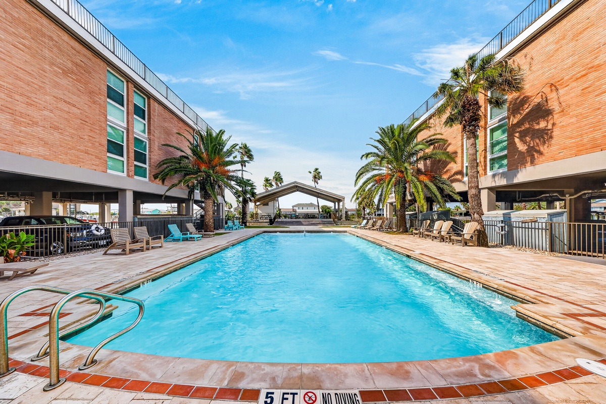 Resort-style waterfront property featuring swimming pool and private dock access on the Gulf Coast.