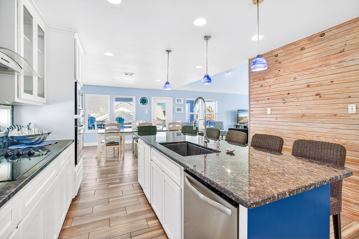Cook and gather around this stunning granite island with modern appliances and coastal charm throughout your spacious kitchen.