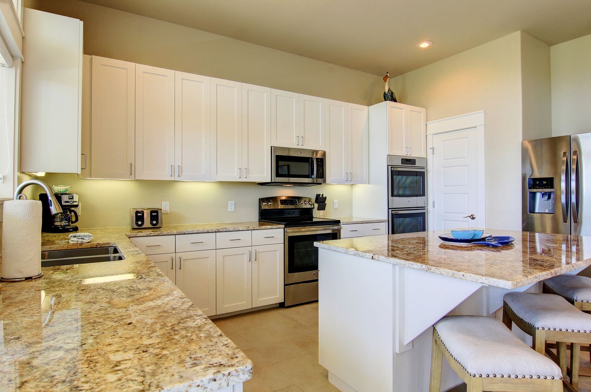 Your spacious kitchen features granite countertops, stainless steel appliances, and everything needed to prepare memorable meals during your stay.