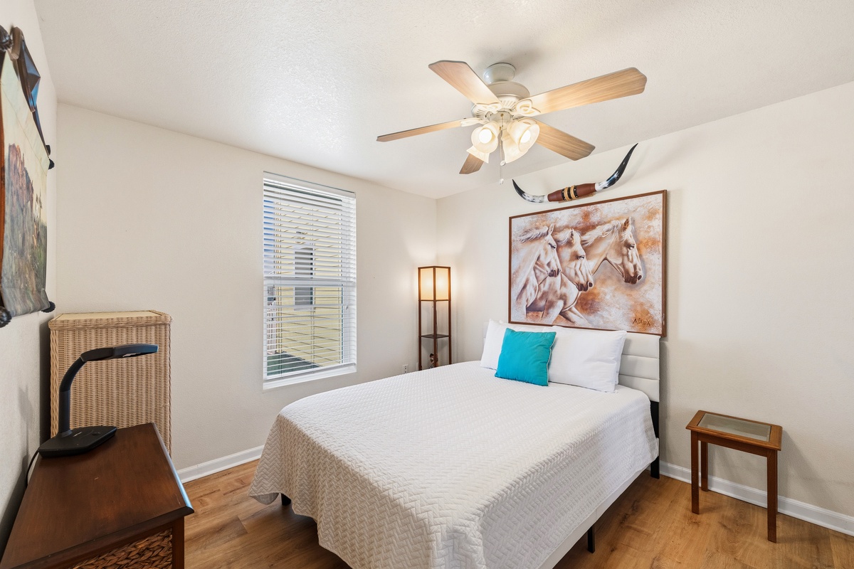Rest easy in your peaceful retreat, where warm wood tones and artistic touches create a welcoming atmosphere perfect for unwinding after a day of adventure.
