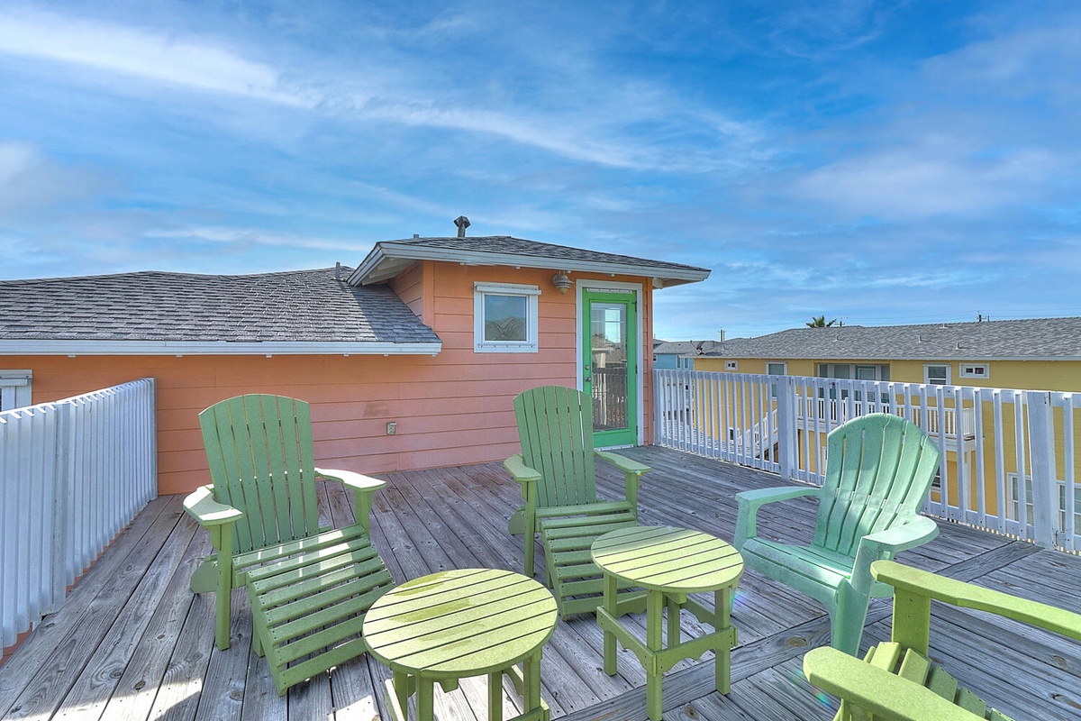 Relax on your private deck with comfortable green Adirondack chairs, perfect for morning coffee or evening conversations under the open sky.