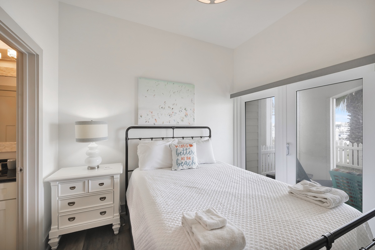 Drift off in your charming coastal bedroom with crisp white linens and cheerful beach vibes.