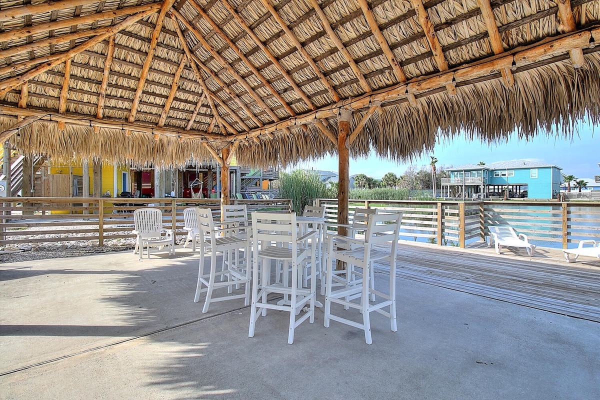Relax under your private thatched-roof palapa with comfortable seating and stunning waterfront views—your perfect outdoor retreat awaits.