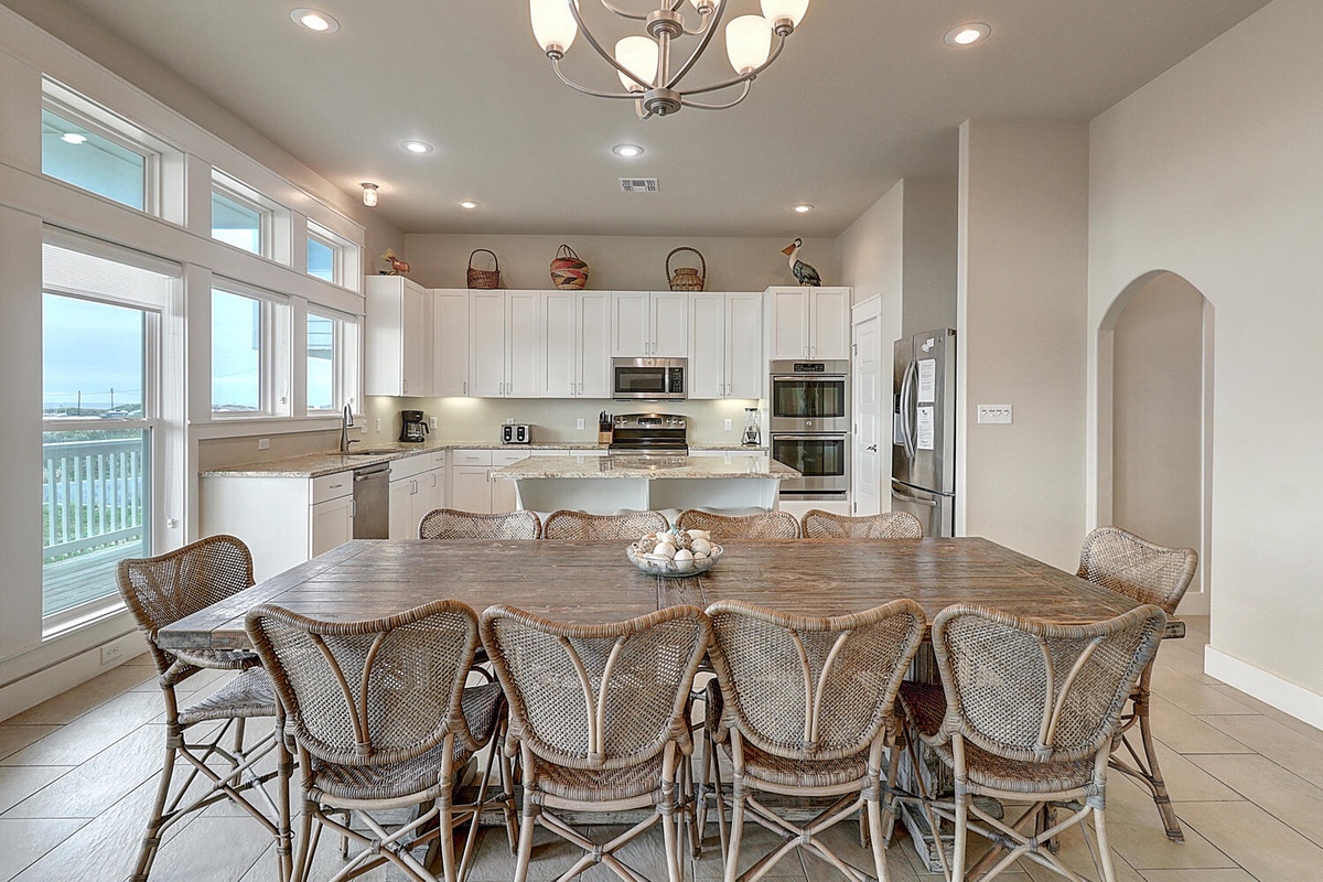 Gather your group around this spacious dining table while the chef prepares meals in the bright, fully-equipped kitchen.