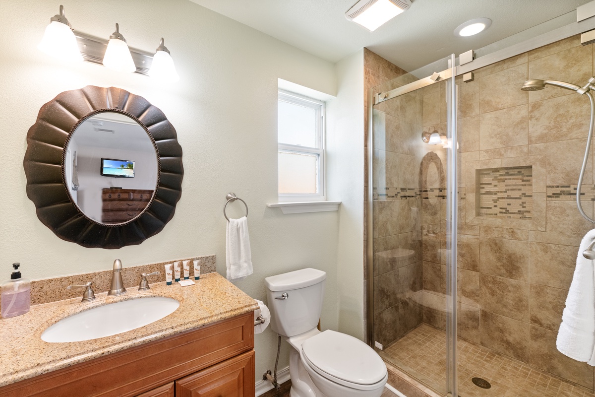 Refresh in your beautifully appointed bathroom featuring a spacious walk-in shower with elegant tile work and modern fixtures.