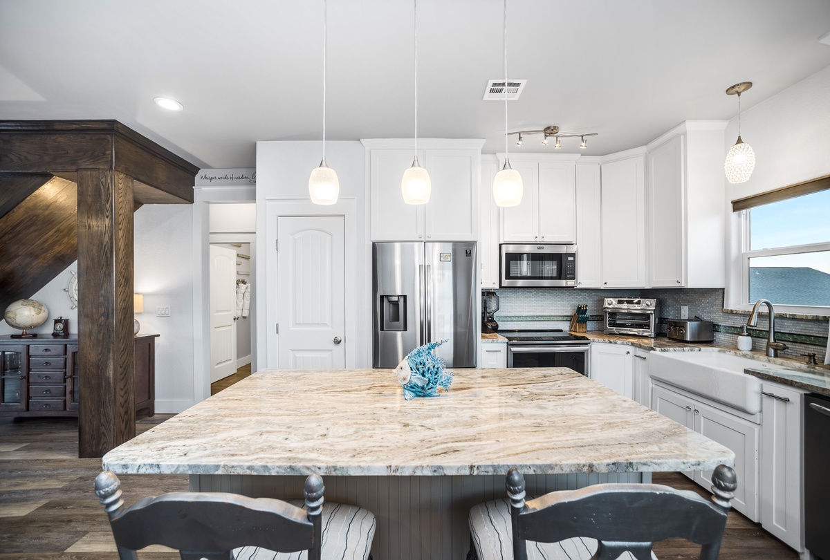 Step into your dream kitchen with gleaming granite countertops, modern stainless appliances, and elegant pendant lighting perfect for cooking memorable meals.
