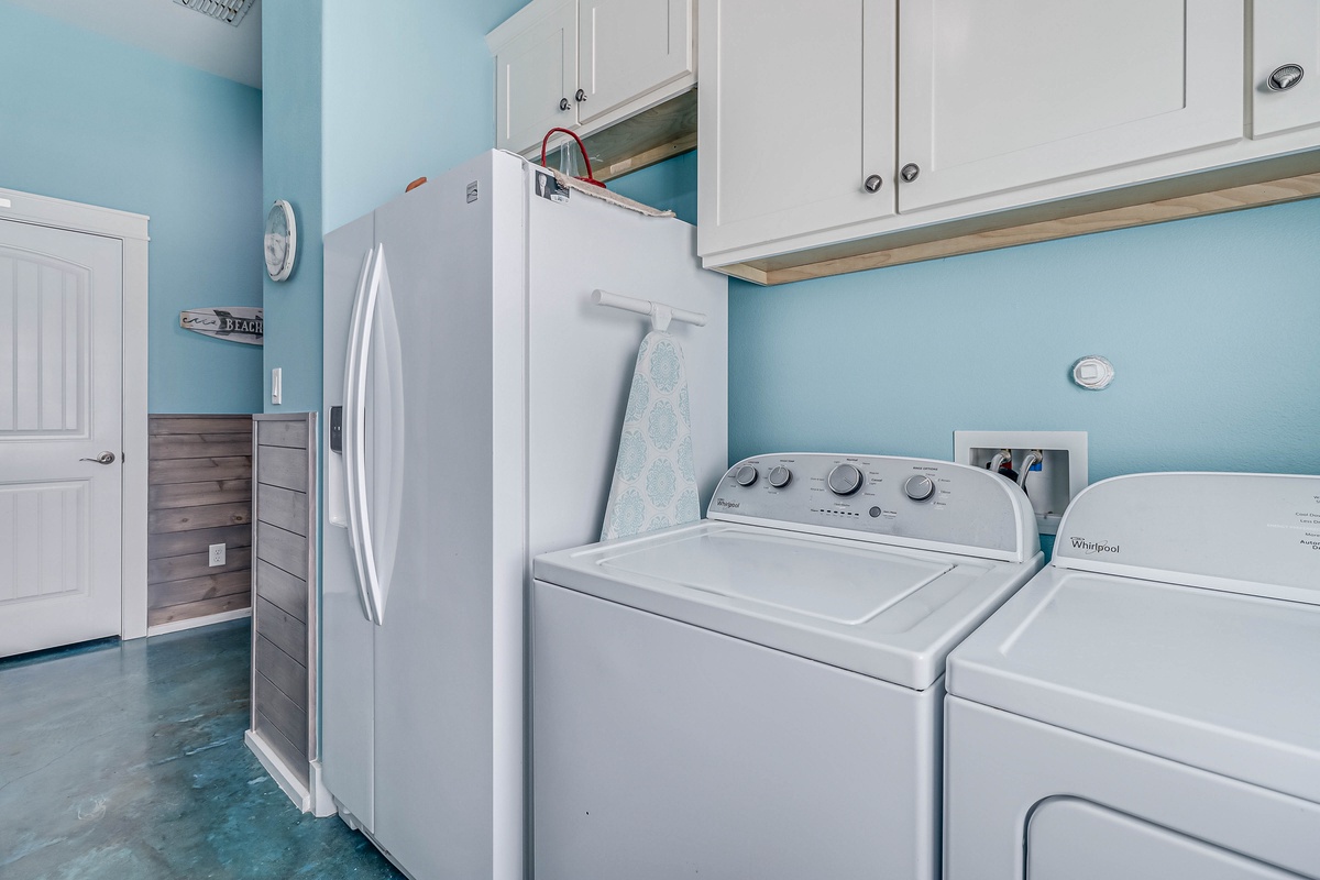 Keep your vacation wardrobe fresh in this bright laundry room with full-size washer and dryer for your convenience.