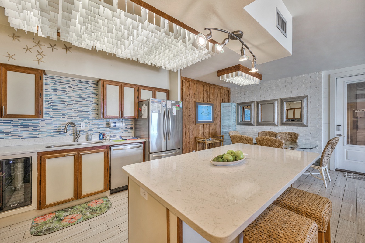 Your gourmet kitchen features marble countertops, modern appliances, and stunning artistic ceiling details for memorable meal preparation.