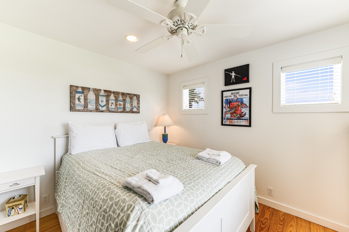 Unwind in your coastal retreat with plush queen bed dressed in soft linens, nautical touches, and gentle Maine light streaming through. Your peaceful night's rest awaits here.
