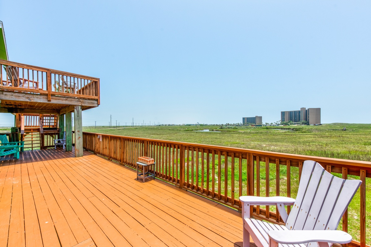 Relax on your private deck with stunning open views across expansive green fields, where comfortable seating awaits your morning coffee moments.