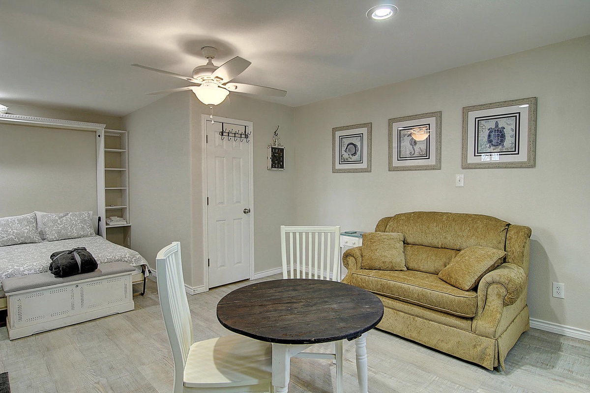 Your bright studio combines comfort and convenience with a plush loveseat, queen bed, and dining table—perfect for relaxing after exploring.