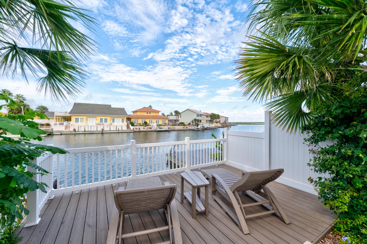 Relax on your private waterfront deck with serene canal views, framed by swaying palms. Picture yourself unwinding in the lounge chair, soaking in peaceful mornings and golden evenings by the water.