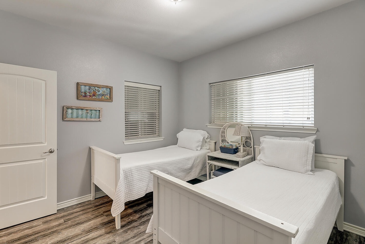 Your twin bedroom offers two comfortable beds with crisp white linens and a charming nautical theme, perfect for siblings or friends.