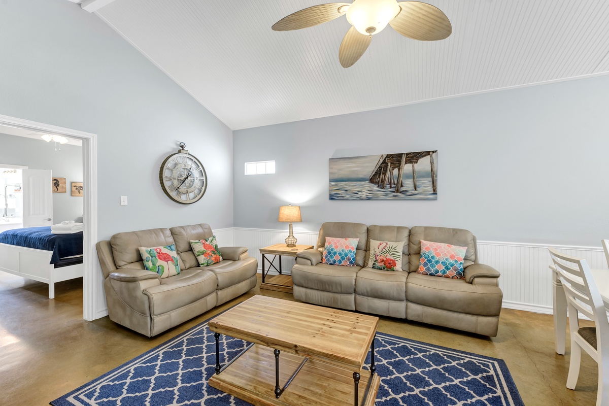 Relax in your coastal living room with plush seating, colorful pillows, and nautical touches that create the perfect beach getaway atmosphere.
