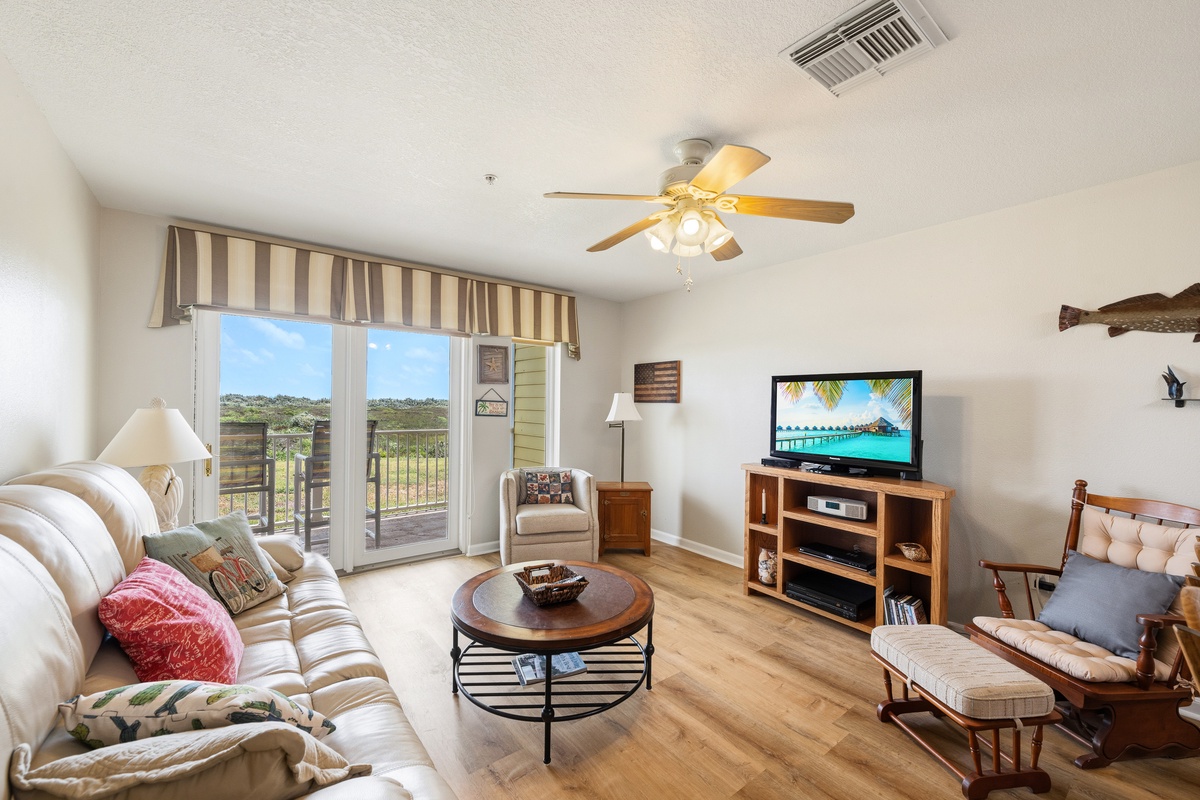 Unwind in your cozy living space where coastal charm meets comfort—plush seating, warm wood accents, and natural light create the perfect retreat after a day of beachside adventures.