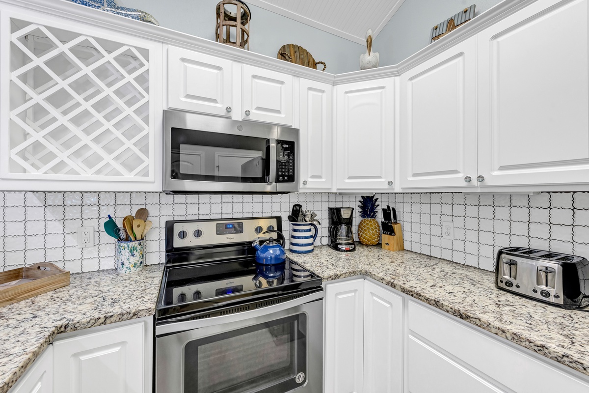 Prepare delicious meals in your fully equipped kitchen featuring granite counters, stainless appliances, and all essentials for culinary adventures.