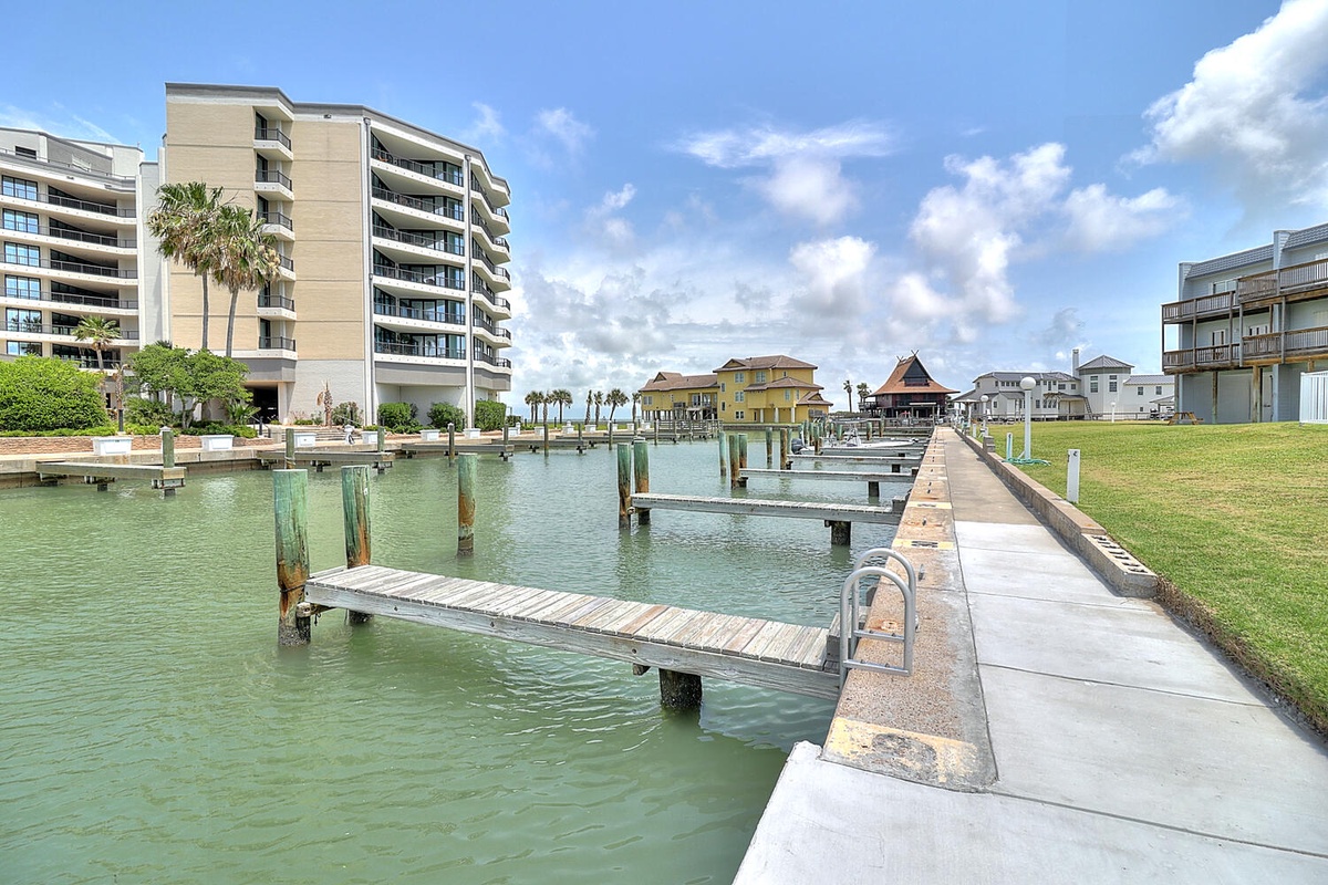 Waterfront property features a private marina with boat slips and direct water access for fishing and boating adventures.