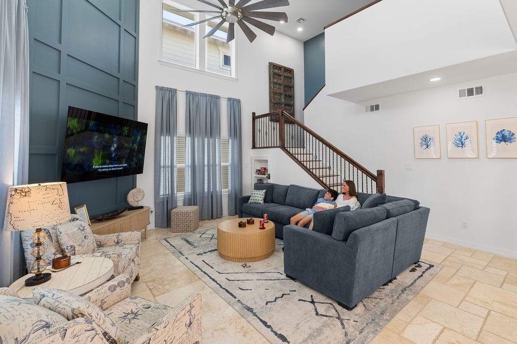 Unwind in your spacious living room with soaring ceilings, cozy sectional seating, and coastal décor that creates the perfect atmosphere for relaxing evenings.