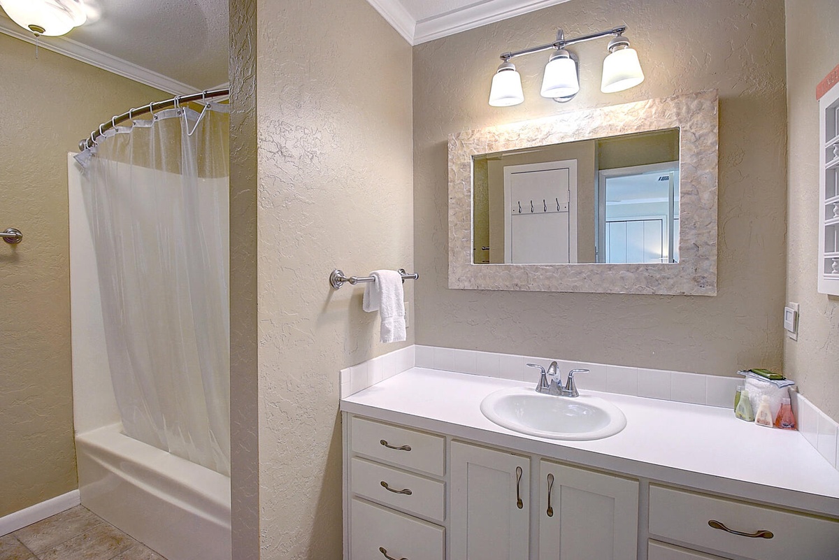 Refresh in your private bathroom with a spacious vanity, elegant mirror, and relaxing shower-tub combo.