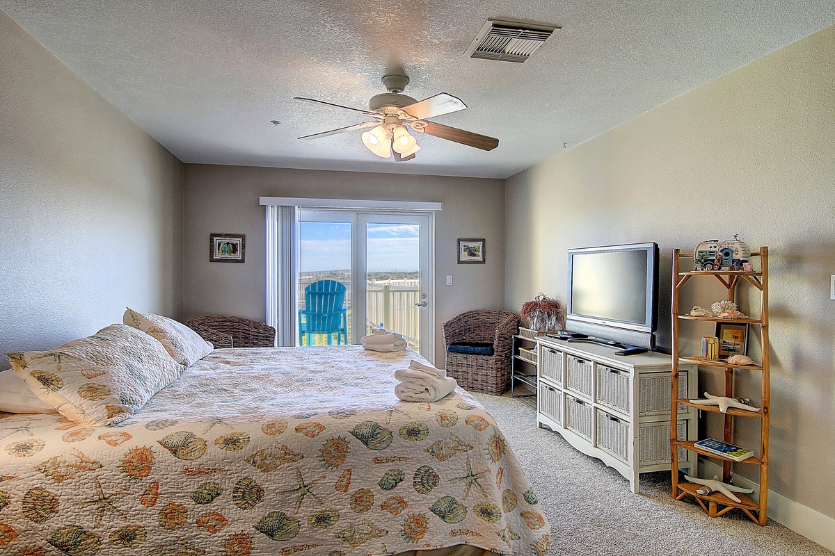 Drift off in your cozy bedroom with ceiling fan comfort and direct balcony access to fresh ocean breezes.