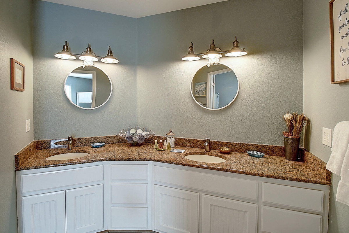 Refresh in your spacious dual-vanity bathroom, where granite countertops and elegant lighting create the perfect morning routine sanctuary.