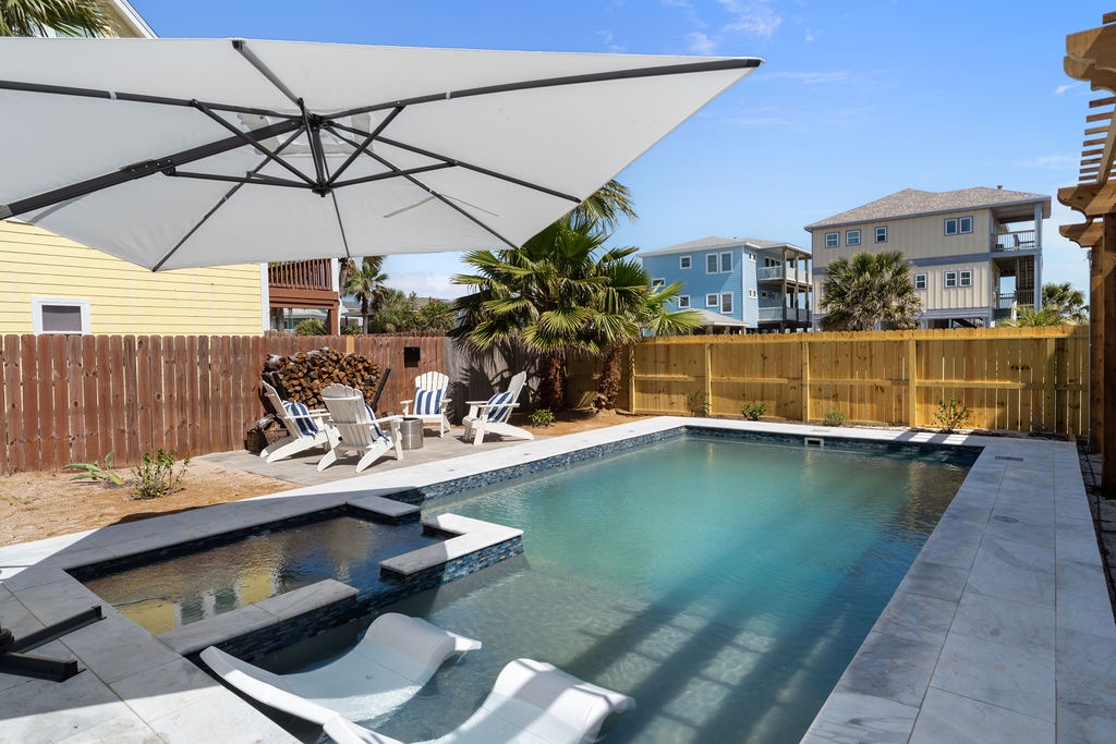 Your private oasis awaits with sparkling pool, relaxing spa, and shaded lounging under swaying palms—perfect for sunny afternoons.