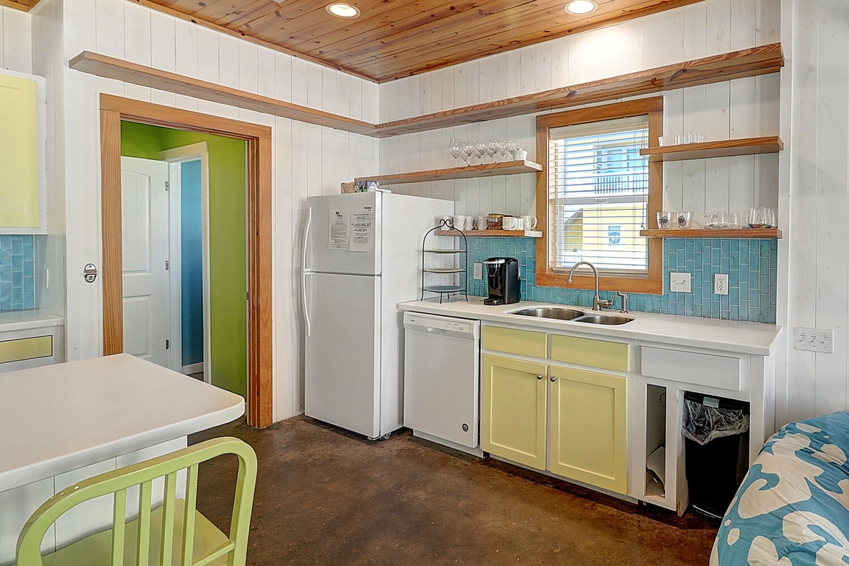 Cook your favorite meals in this bright cottage kitchen featuring cheerful colors, modern appliances, and everything you need for a comfortable stay.
