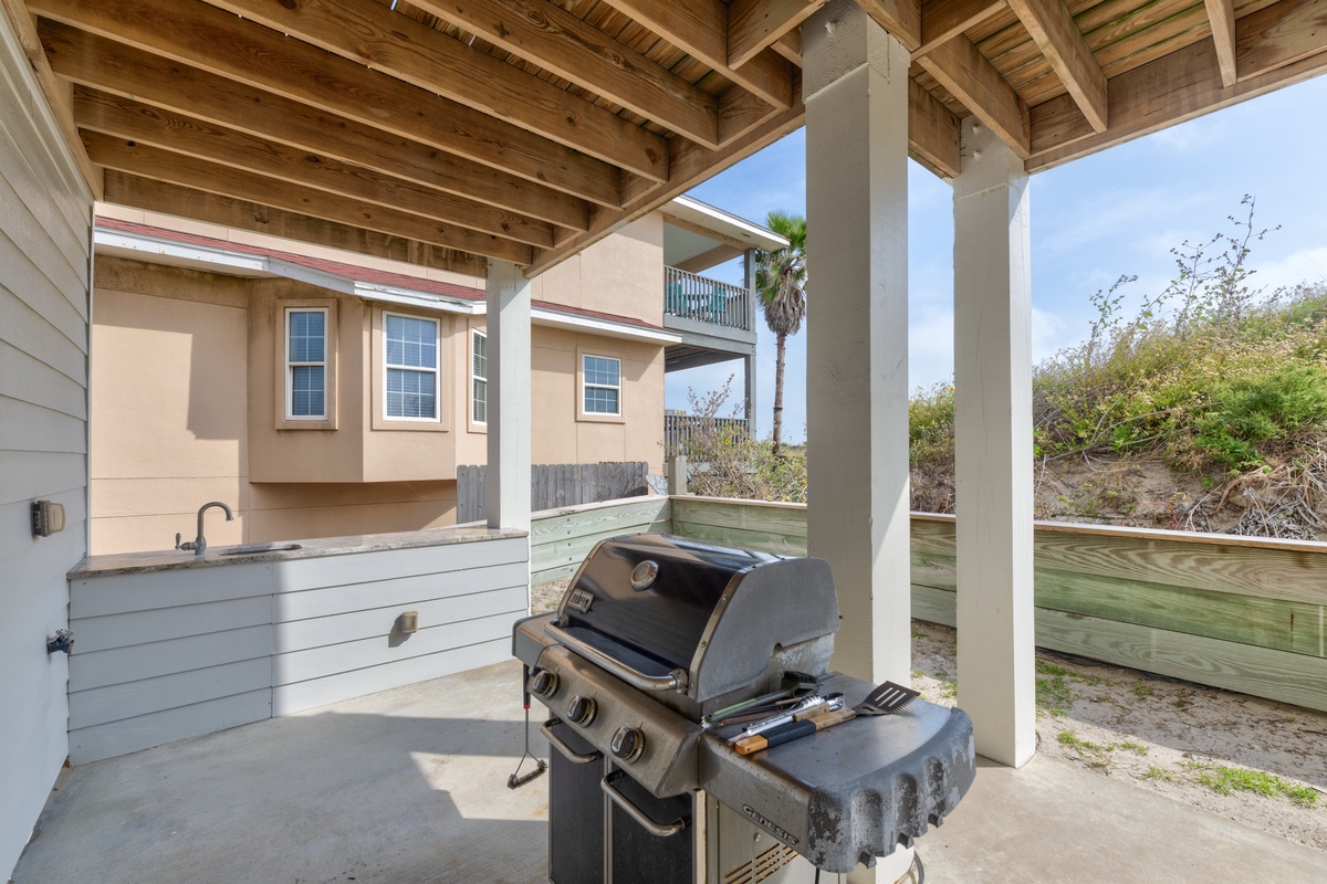 Fire up your favorite meals on this spacious covered patio, where warm coastal breezes and exposed beam ceilings create the perfect grilling experience.