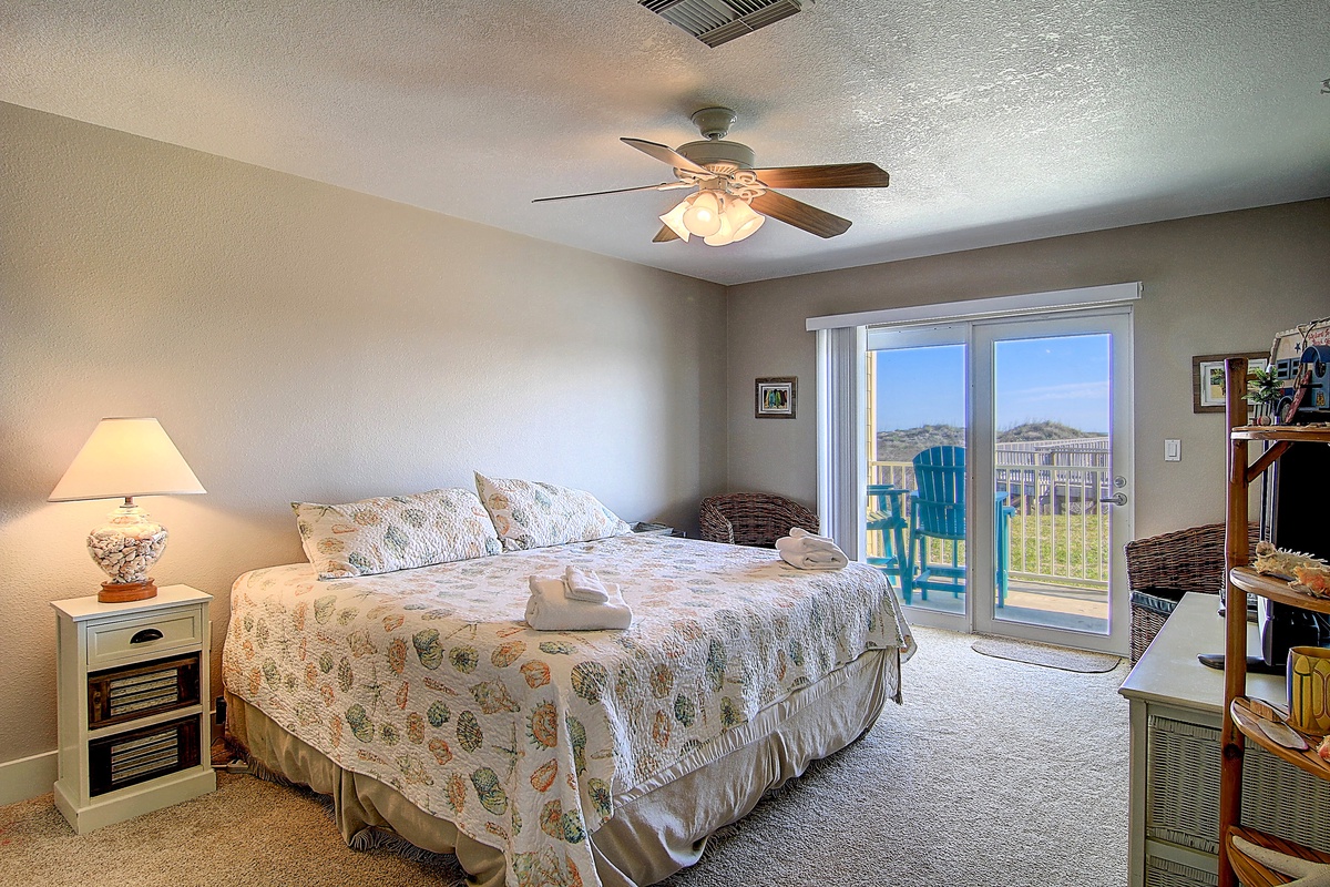 Wake up in your comfortable bedroom where soft morning light filters through sliding doors to your private balcony overlooking peaceful countryside views.