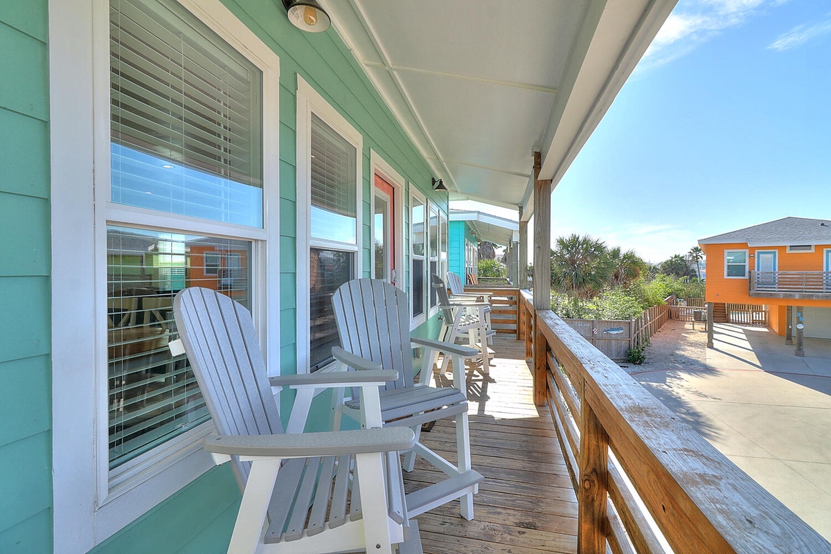 Your private covered deck offers perfect morning coffee moments with coastal breezes and colorful neighborhood views.
