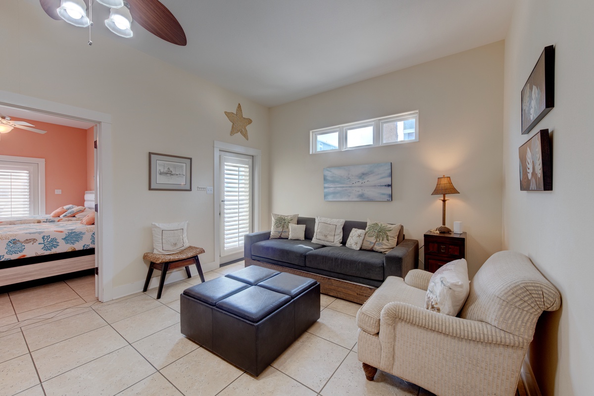 Sink into coastal comfort in your spacious living room, where soft seating and beach-inspired decor create the perfect retreat after sandy adventures.