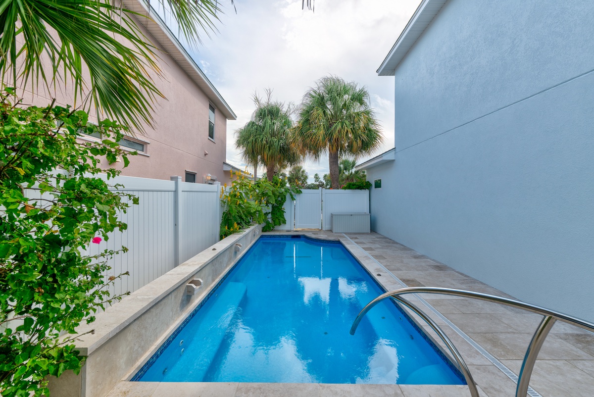 Your private pool awaits beneath swaying palms and coastal sky—a serene spot to cool off after sun-soaked adventures.