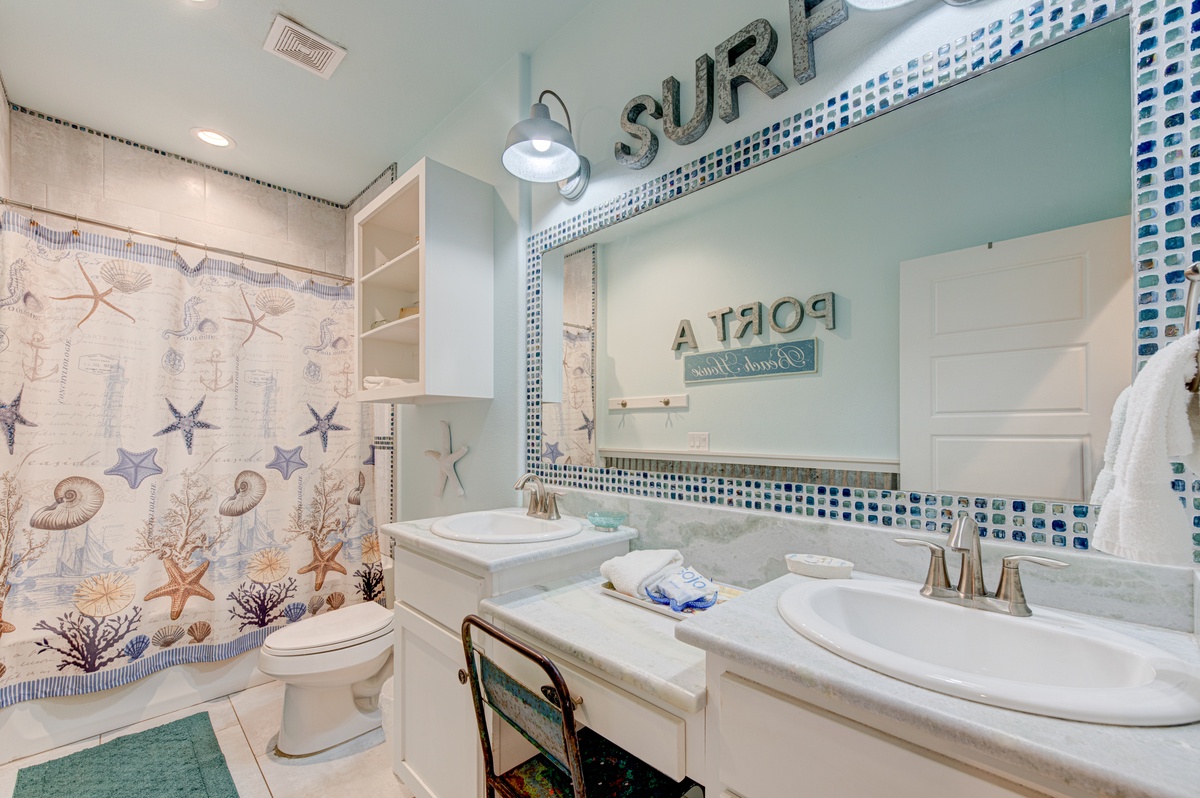 Your coastal-themed bathroom features ocean-inspired tiles and nautical touches that bring seaside charm to your daily routines.