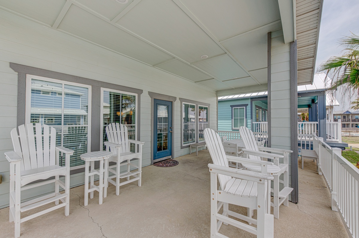 Unwind on your spacious covered porch with comfortable seating, perfect for morning coffee or evening relaxation while enjoying the coastal atmosphere.