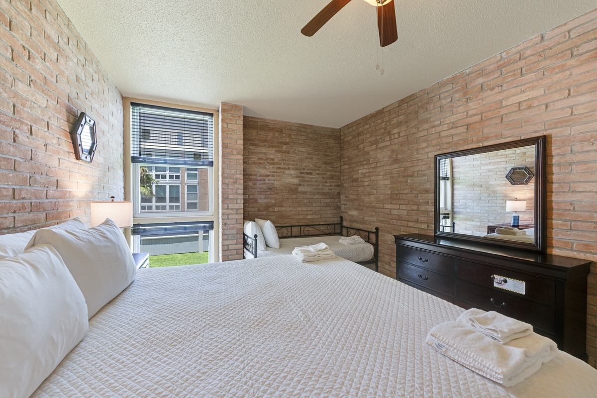 Natural light and flexible sleeping arrangements make this inviting bedroom a relaxing retreat for families and friends.