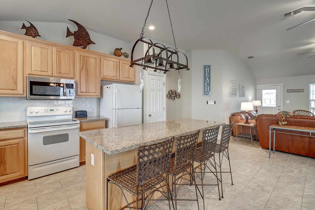 Your spacious kitchen invites memorable meals with granite counters, stainless appliances, and bar seating for casual dining conversations.