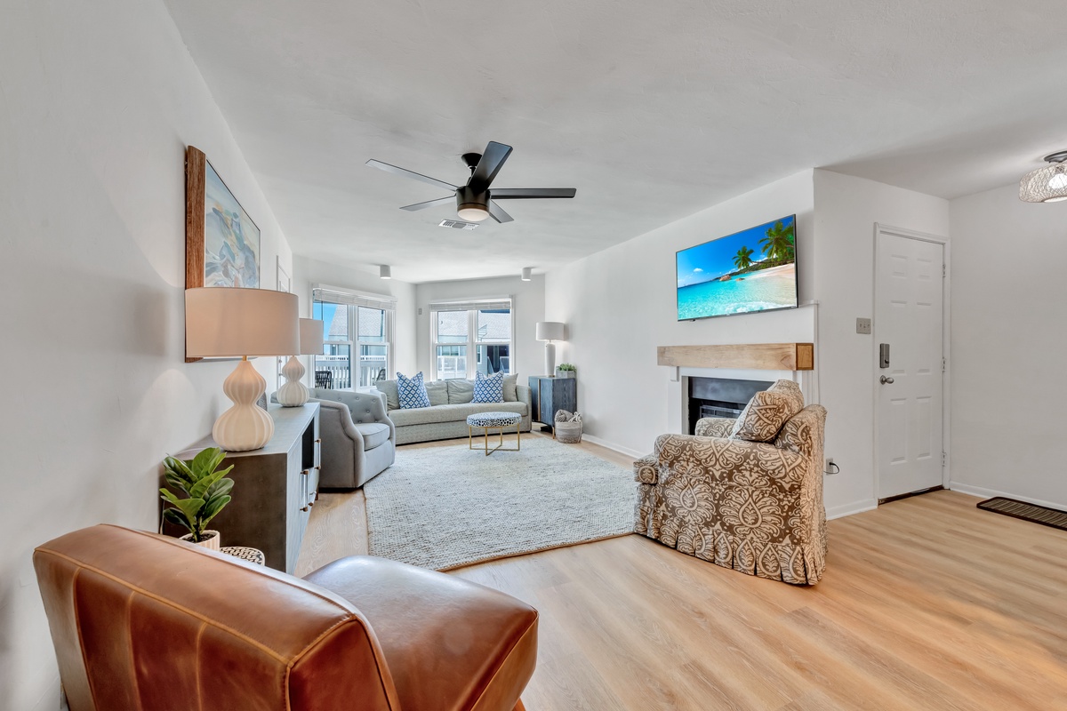 Unwind in your bright, spacious living room featuring cozy seating, a warming fireplace, and modern touches perfect for relaxing after exploring.