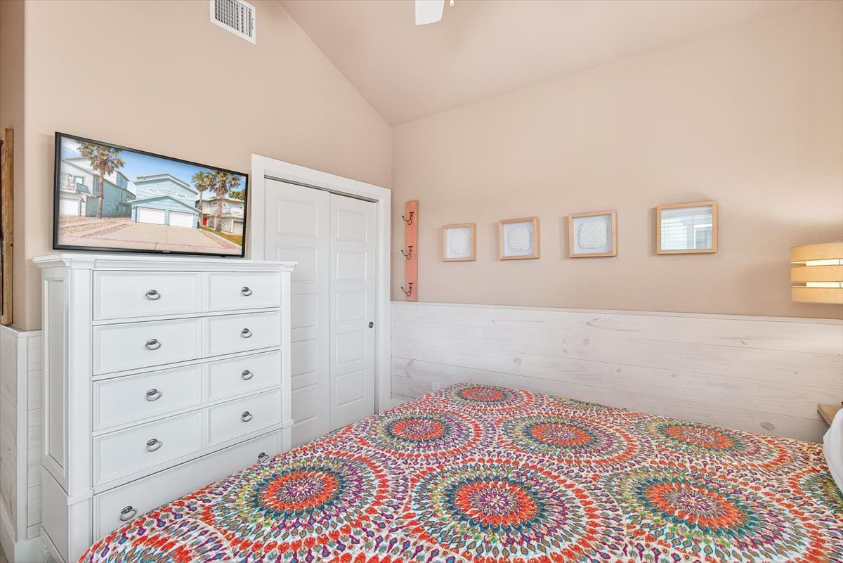 Unwind in your bright bedroom with vibrant linens, ample storage, and a mounted TV for your favorite shows.
