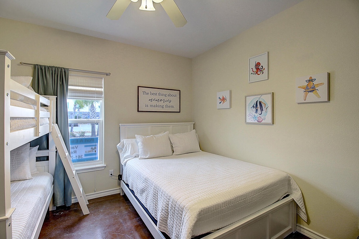 Your cozy bedroom features comfortable beds and cheerful nautical artwork, creating the perfect family-friendly retreat.