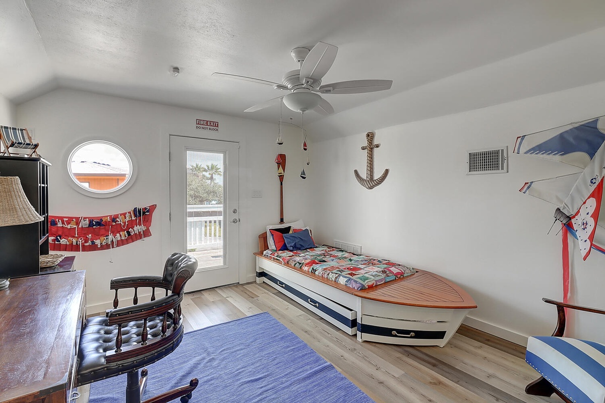 Your kids will love this nautical-themed bedroom with a unique boat-shaped bed and playful maritime décor throughout.
