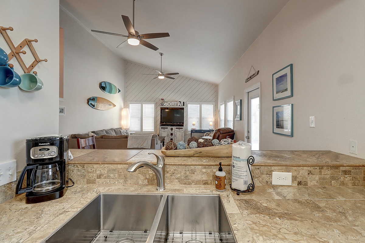 Your open kitchen flows seamlessly into the living area, where granite countertops and stainless steel sink create your perfect cooking space.