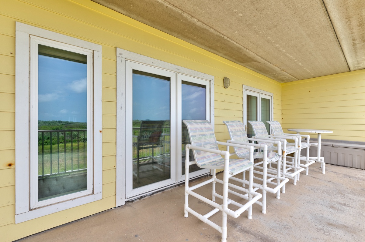 Settle into your private patio and soak in peaceful field views. Four chairs invite you to linger over morning coffee or evening conversation while enjoying the fresh air and natural scenery stretching beyond the railing.