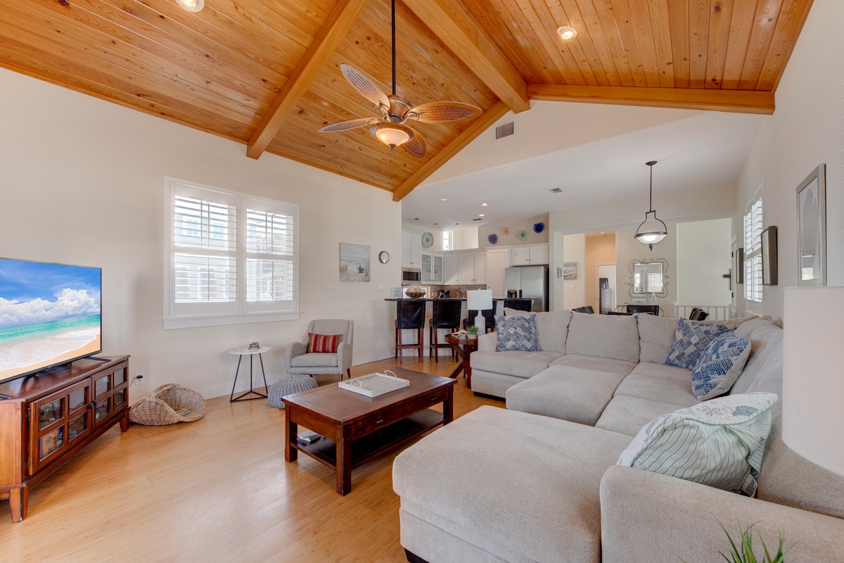 Relax in your spacious living room with soaring wood-beamed ceilings, plush sectional seating, and an open-concept design perfect for gathering.