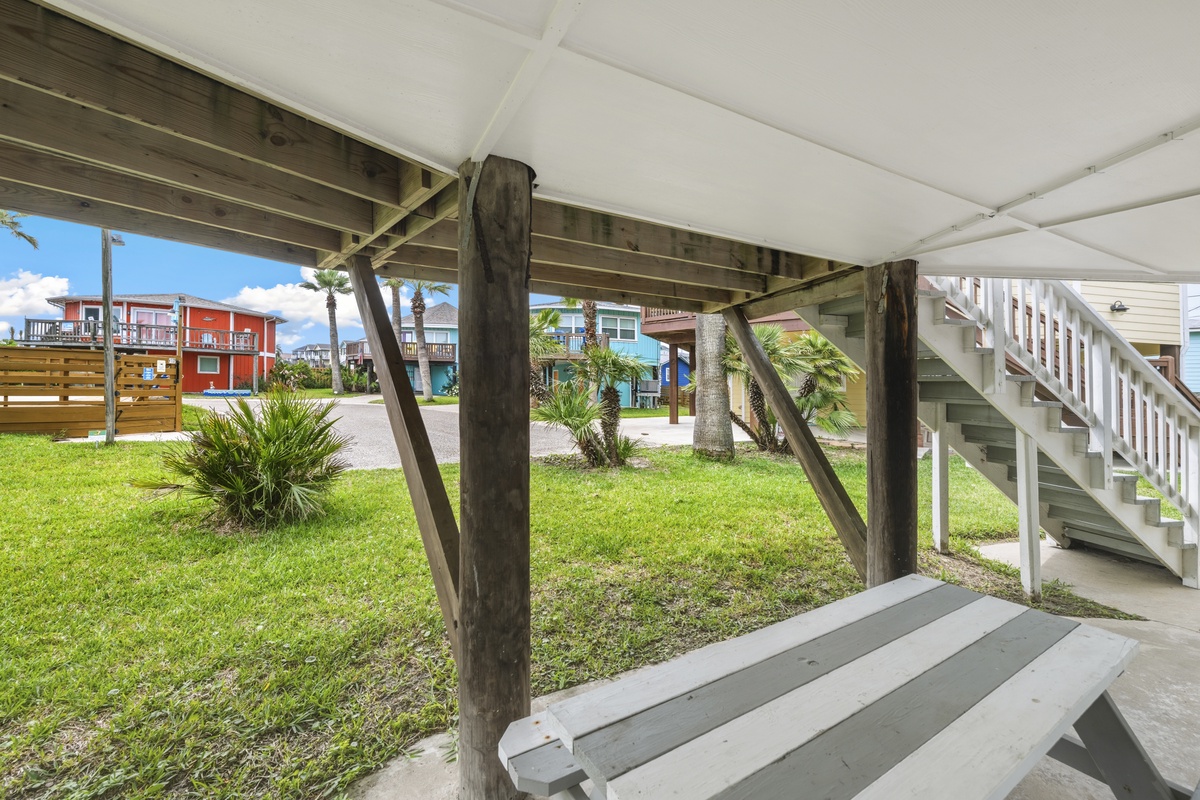 Your covered outdoor space offers peaceful relaxation with tropical views and convenient picnic seating.