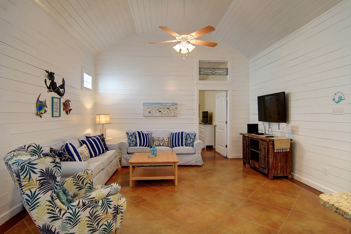 Sink into tropical comfort in your coastal living room with nautical touches and cool island breezes from the ceiling fan above.