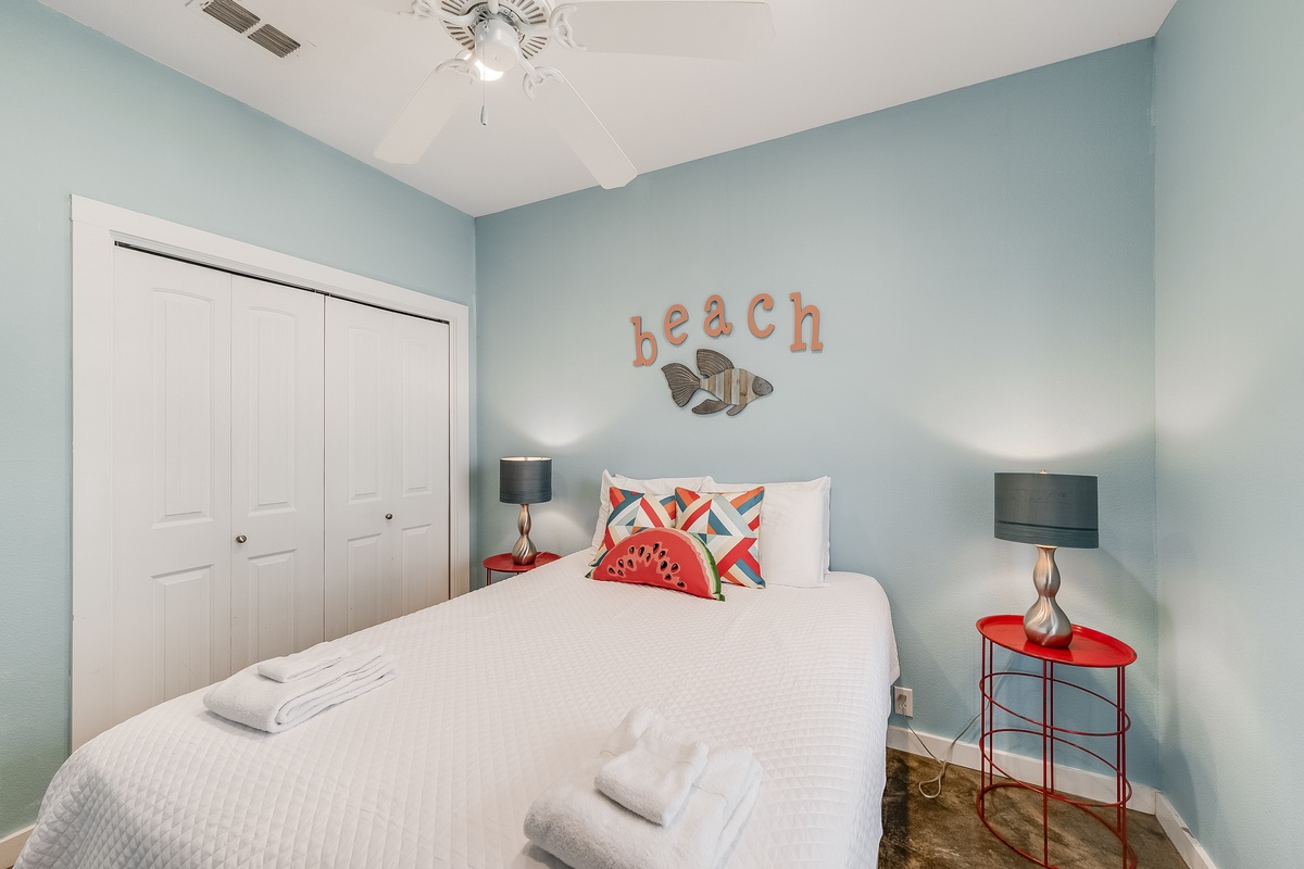 Drift off to sweet dreams in this coastal-themed bedroom, where soft blue walls and beach vibes create your perfect seaside retreat.