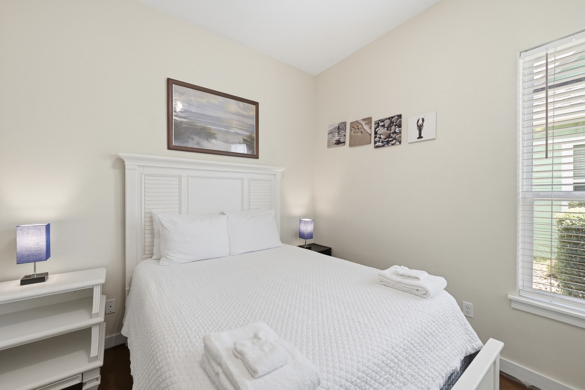 Relax in this charming coastal retreat, where crisp white linens and nautical-inspired décor create a peaceful haven for restful nights.