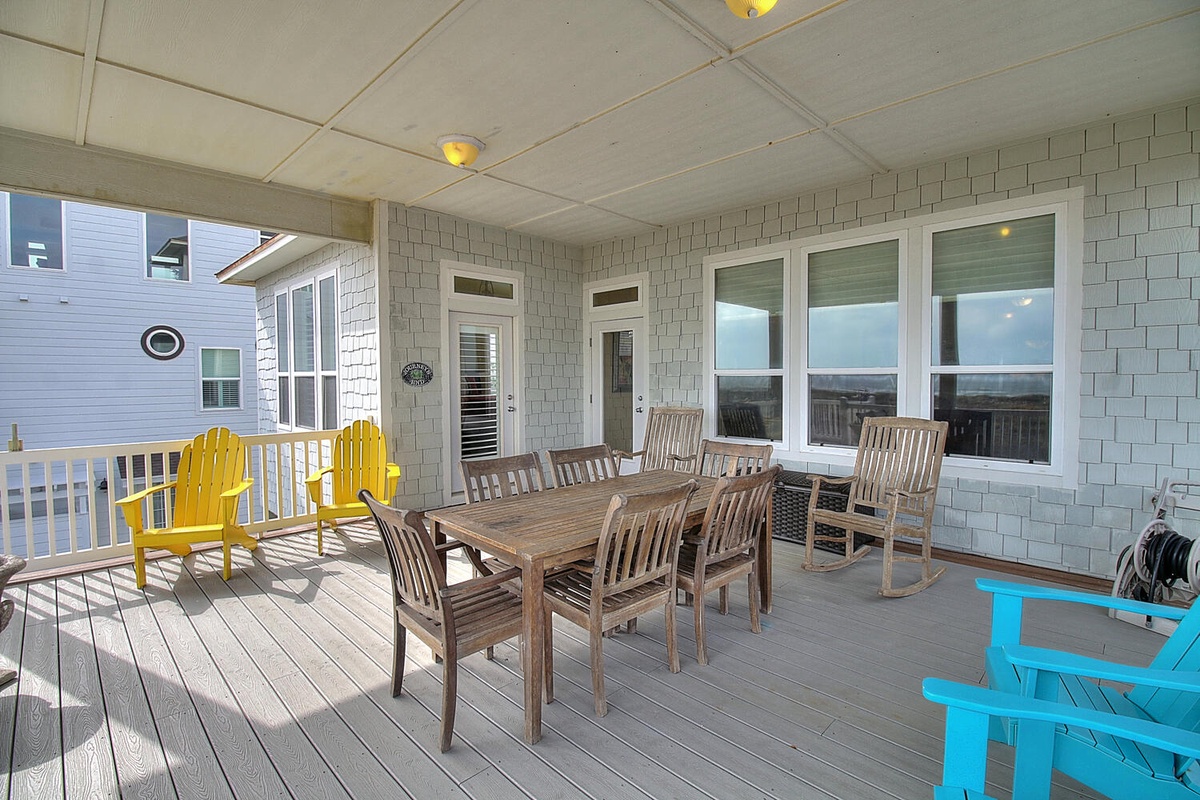 Your spacious covered deck offers comfortable dining for eight plus rocking chairs for peaceful moments overlooking the neighborhood.
